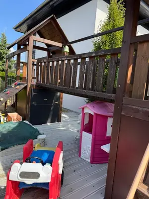 a childs bed and a play house on a deck at Luxury Prague House in Herink
