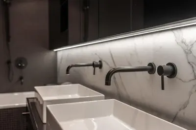 a bathroom with two white sinks and a mirror at Luxury Old Town Penthouse w park in Prague