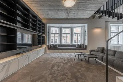 a living room with a couch and a table at Luxury Old Town Penthouse w park in Prague