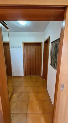 a hallway with doors and a tiled floor at Apartmán ANNA