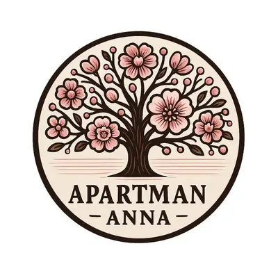 a tree with pink flowers in a circle logo at Apartmán ANNA