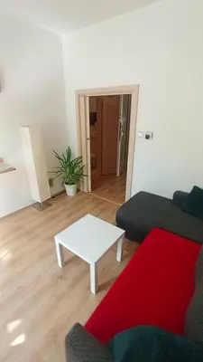 a living room with a couch and a coffee table at Bright and cozy - 3 min to Old town square in Prague