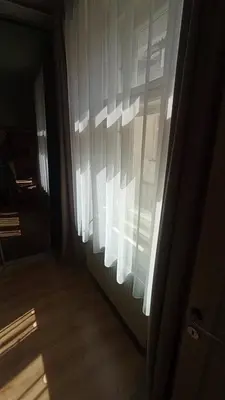 a window with white curtains in a room at Bright and cozy - 3 min to Old town square in Prague