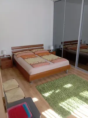 a bedroom with a bed and a green rug at Bright and cozy - 3 min to Old town square in Prague