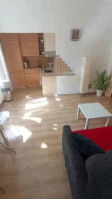 a living room with a couch and a table at Bright and cozy - 3 min to Old town square in Prague