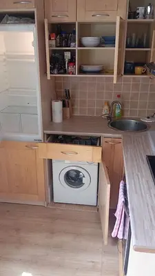 a kitchen with a sink and a washing machine at Bright and cozy - 3 min to Old town square in Prague