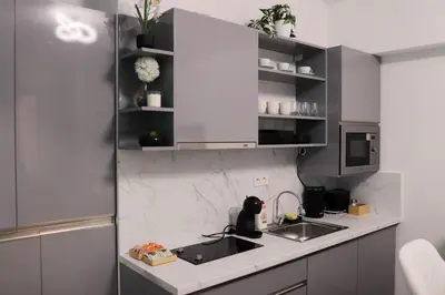 a kitchen with a sink and a microwave at Stylish Stay at the Heart of Prague! in Prague