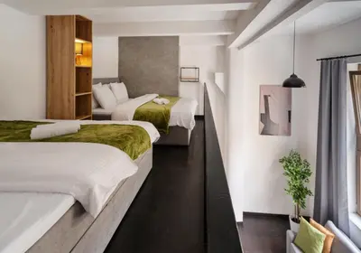 a hotel room with two beds and a staircase at Loft cozy studios in Prague Center in Prague