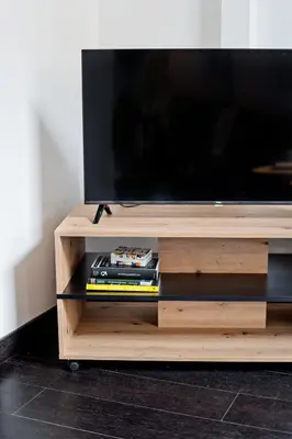 a flat screen tv on a wooden entertainment center at Loft cozy studios in Prague Center in Prague
