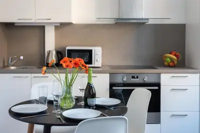 a kitchen with a table with chairs and a microwave at Loft cozy studios in Prague Center in Prague