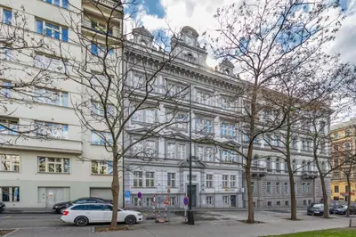 a white building with a clock tower on top of it at Prague Center Apt - 2 min to Wenceslas Sq, Praha 1 in Prague