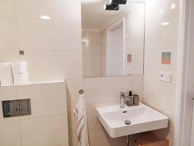 a bathroom with a washing machine and a toilet at Prague Center Apt - 2 min to Wenceslas Sq, Praha 1 in Prague