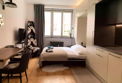a bedroom with a bed and a desk and a window at Cosy Apartment near City Center in Prague