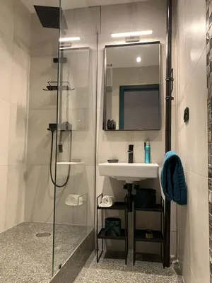 a bathroom with a sink and a shower at Cosy Apartment near City Center in Prague