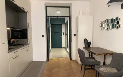 a kitchen with a table and chairs and a dining room at Cosy Apartment near City Center in Prague