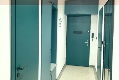 a hallway with a blue door in a building at Cosy Apartment near City Center in Prague
