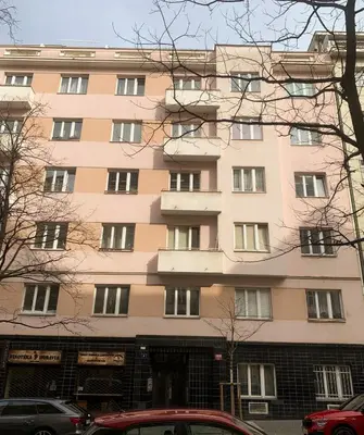 a tall building with cars parked in front of it at Cosy Apartment near City Center in Prague