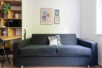 a blue couch sitting in a living room at Cozy studio in centre of prague 10 Vrsovice in Prague