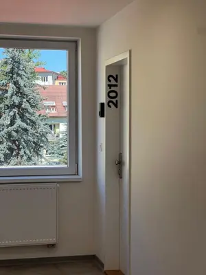 a room with a door and a window and a christmas tree at Cozy studio in centre of prague 10 Vrsovice in Prague