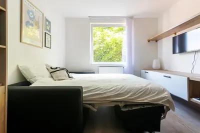 a bedroom with a large bed and a window at Cozy studio in centre of prague 10 Vrsovice in Prague