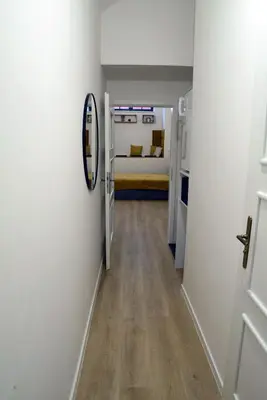 a hallway with a bed and a mirror in a room at The Nook I Soukromý apartmán v srdci Prahy in Prague
