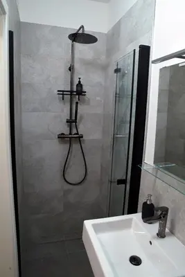 a bathroom with a shower and a sink at The Nook I Soukromý apartmán v srdci Prahy in Prague