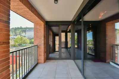 an empty balcony of a building with glass doors at Apartman made by David Černý in Prague