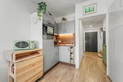 a small kitchen with a sink and a microwave at Stylish Studio in Smichov, Private parking, Free Gym in Prague