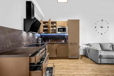 a kitchen with a counter top and a couch at New cozy apartment, Free Parking! in Prague