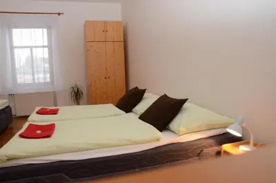 a bedroom with a large bed with two pillows at Apartments Karlin in Prague