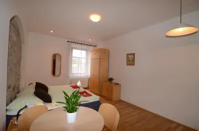 a bedroom with a bed and a table in it at Apartments Karlin in Prague