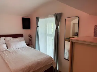a bedroom with a bed and a large mirror at LublaDeluxe in Prague