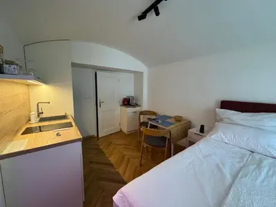 a bedroom with a bed and a kitchen with a sink at LublaDeluxe in Prague