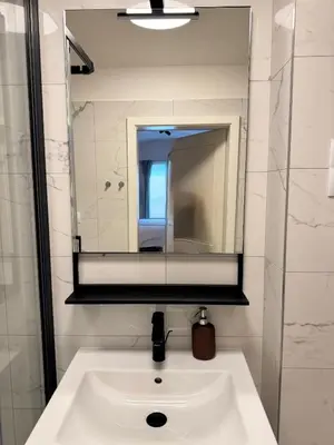 a white sink in a bathroom with a mirror at LublaDeluxe in Prague