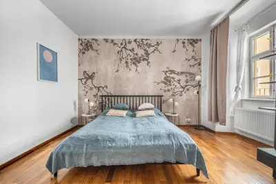 a bedroom with a bed and a wall with flowers at Cozy apartment in the Old town in Prague