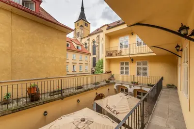 a balcony with two umbrellas and a building at Cozy apartment in the Old town in Prague