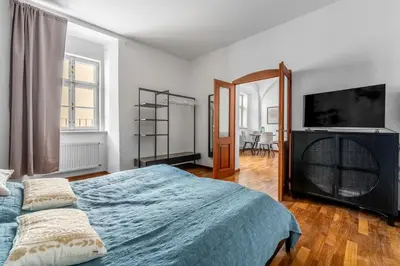 a bedroom with a bed and a flat screen tv at Cozy apartment in the Old town in Prague