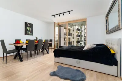 a bedroom with a bed and a dining room at Bright Royal Elegance in Prague