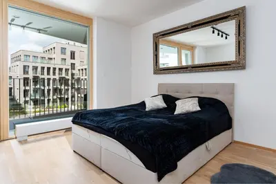 a bedroom with a bed and a mirror on the wall at Bright Royal Elegance in Prague