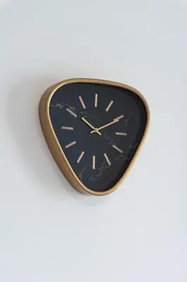 a black and gold clock on a white wall at Bright Royal Elegance in Prague