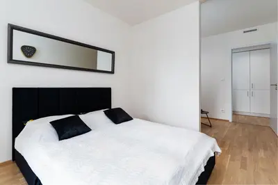 a bedroom with a bed with a mirror on the wall at Bright Royal Elegance in Prague