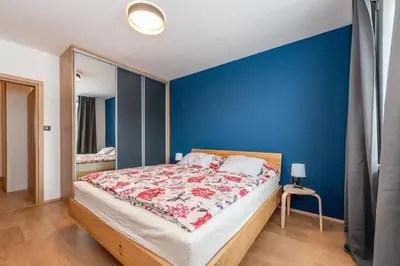 a bedroom with a blue wall and a bed at Luxury modern apartment near the metro - 10 minutes to the city center in Prague