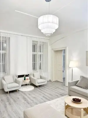 a living room with white furniture and a chandelier at Elegant Cozy Apartment In center Prague in Prague