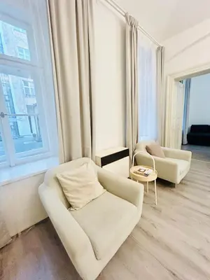 a living room with two chairs and a window at Elegant Cozy Apartment In center Prague in Prague