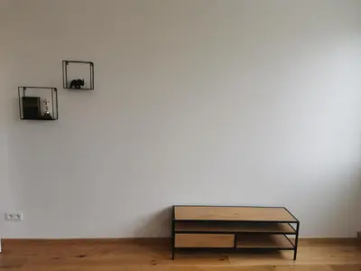 a table in front of a white wall with two pictures at Glamour & Prague in Prague