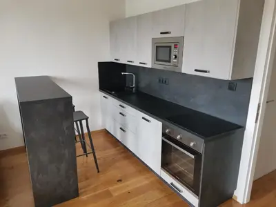 a kitchen with a black counter top and a microwave at Glamour & Prague in Prague