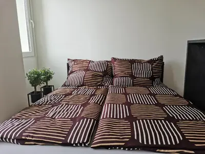 a bed with two pillows and a blanket on it at Glamour & Prague in Prague