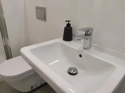 a white bathroom with a sink and a toilet at Glamour & Prague in Prague