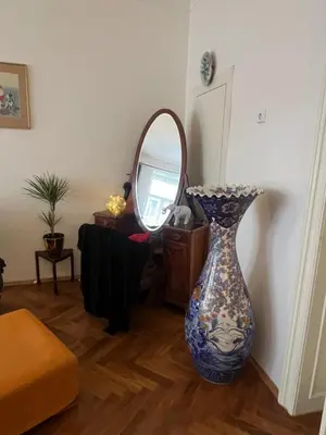 a vase sitting on the floor in front of a mirror at Štěpánká - Lucerna 1 in Prague