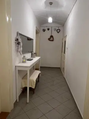 a hallway with a white table and a mirror at Štěpánká - Lucerna 1 in Prague